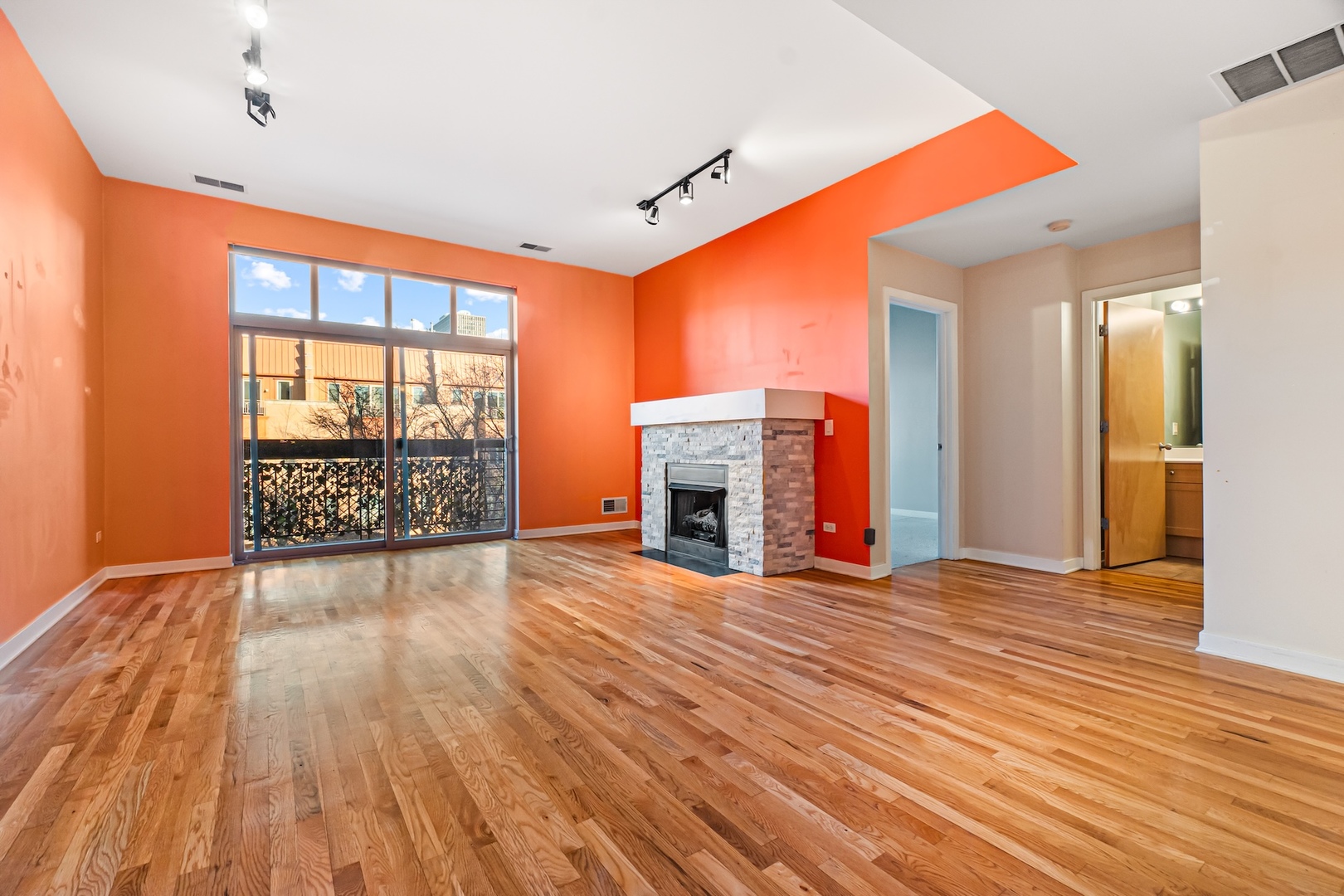 1910 South State Street, Unit 305 Chicago, IL 60616 - Photo 4 of 20 a view of an empty room with wooden floor and a fireplace