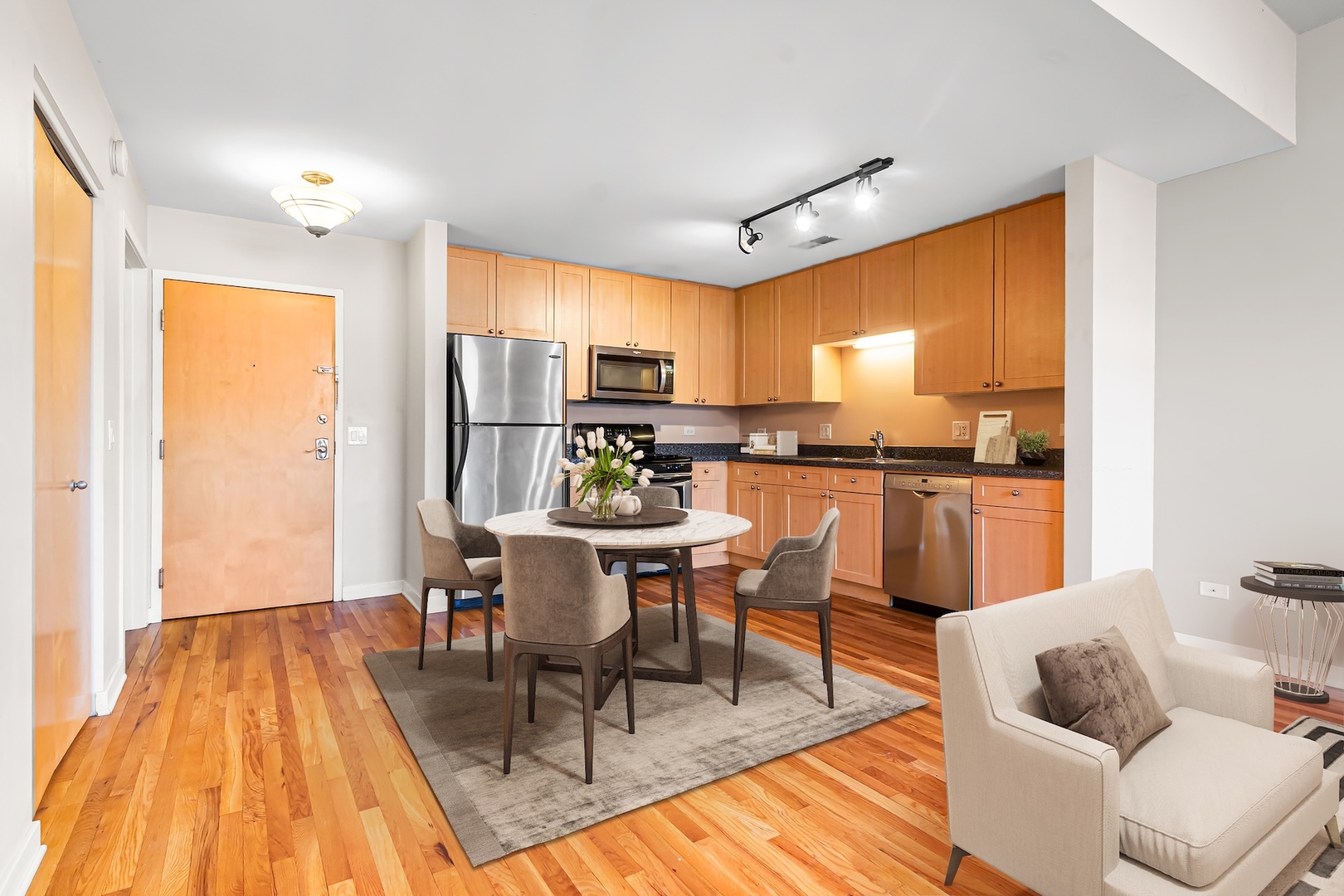 1910 South State Street, Unit 305 Chicago, IL 60616 - Photo 10 of 20 a living room with stainless steel appliances kitchen island granite countertop furniture and a wooden floor