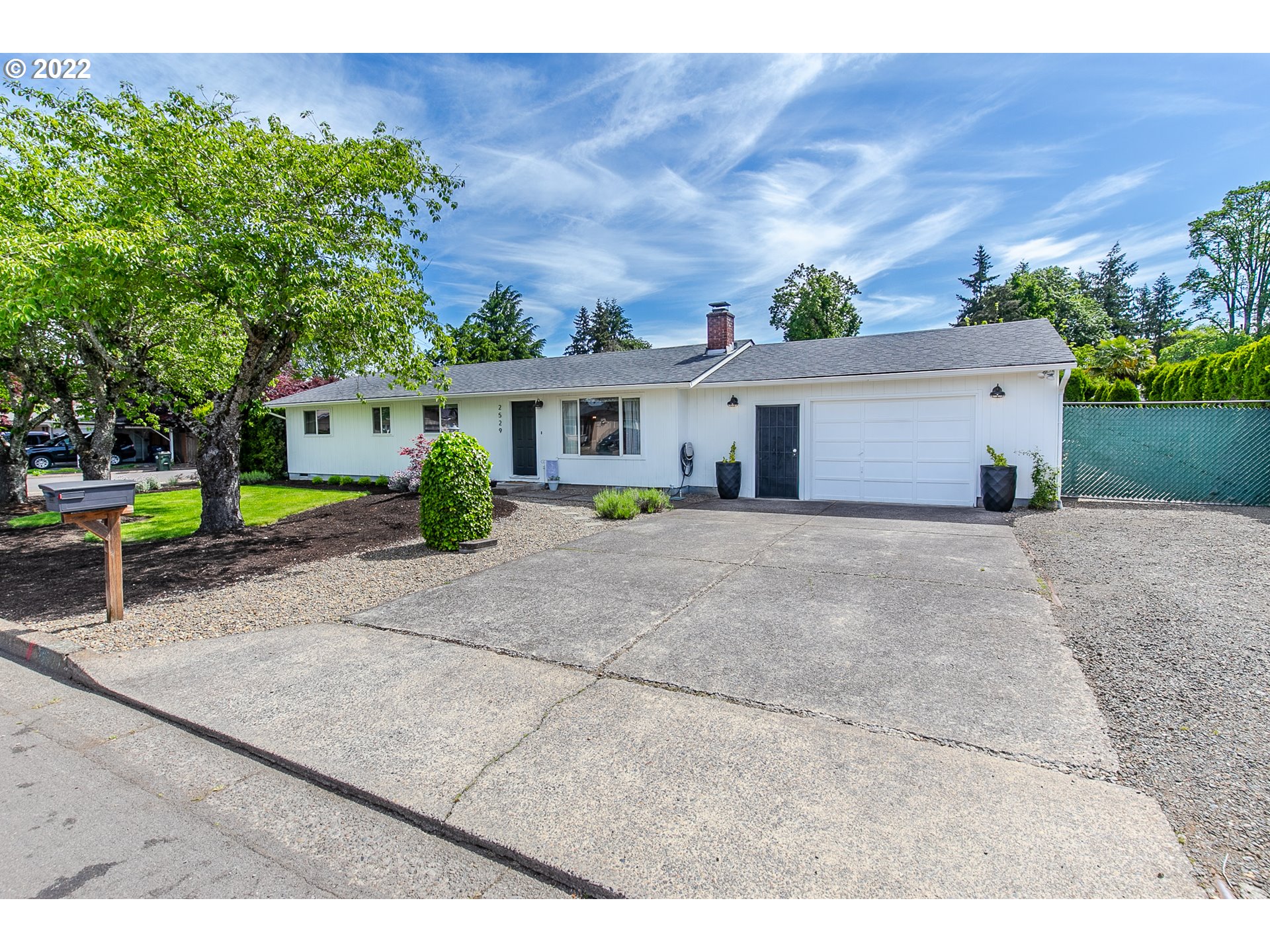 2529 27th Street Springfield, OR 97477 - Photo 2 of 20 a view of house with a yard and potted plants