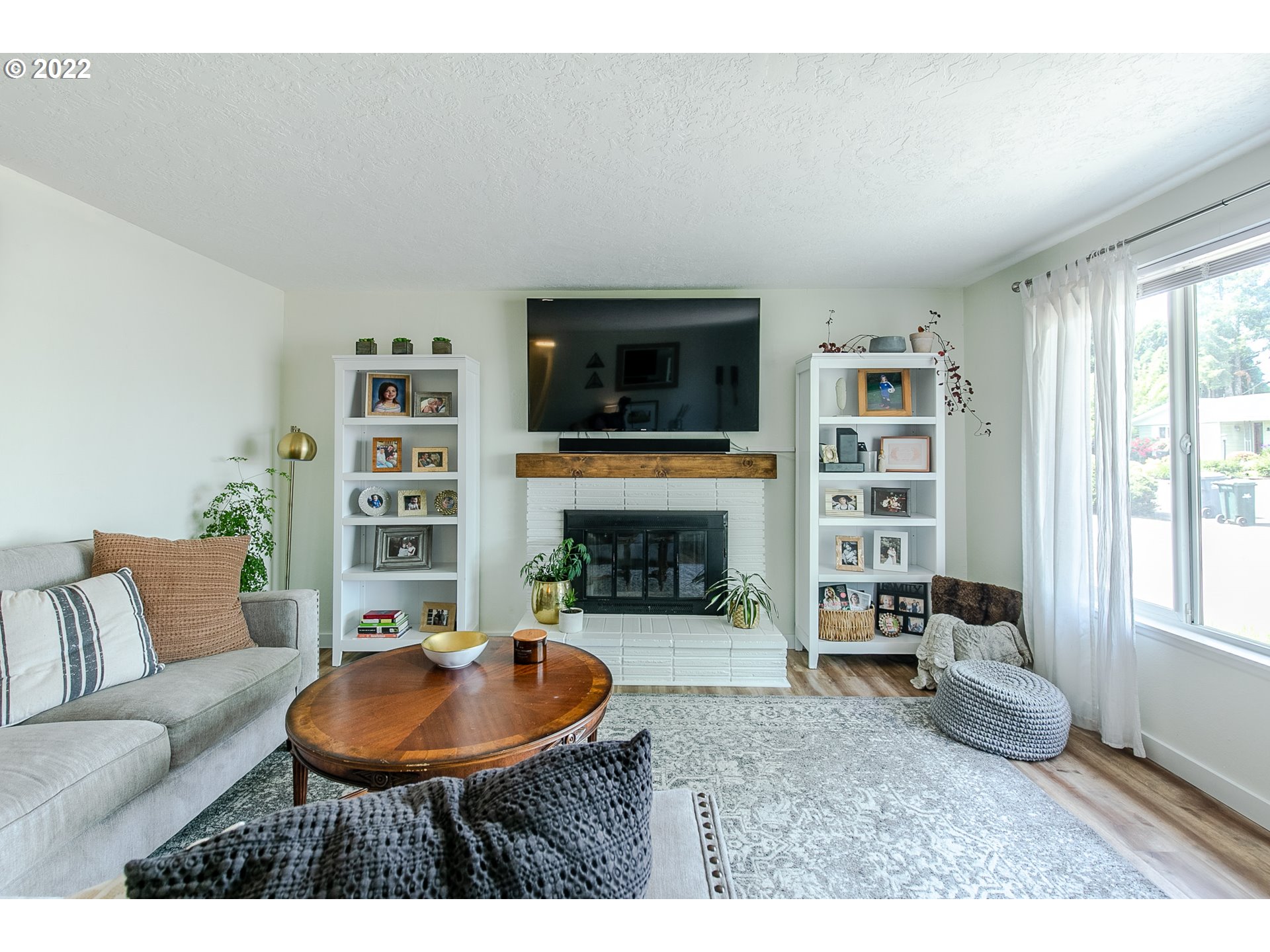 2529 27th Street Springfield, OR 97477 - Photo 4 of 20 a living room with furniture a fireplace and a flat screen tv