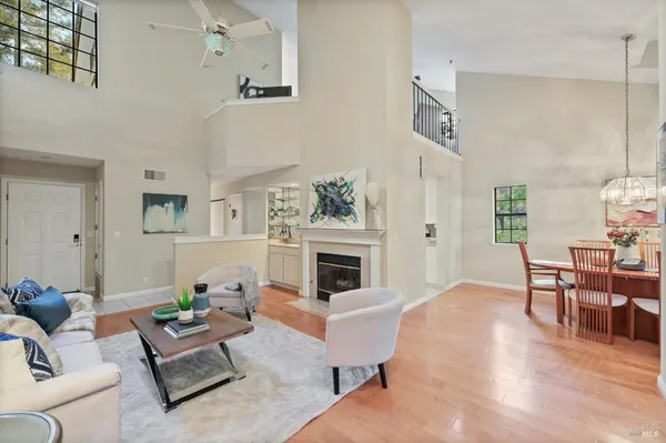 a living room with furniture fireplace and dining table