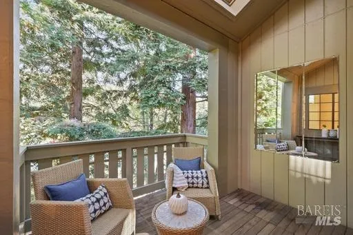 a balcony with furniture and wooden floor