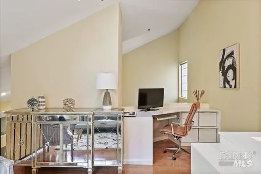 a view of a workspace with furniture and a flat screen tv