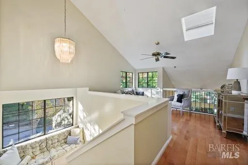a view of a kitchen with a sink wooden floor and a chandelier
