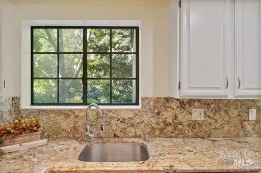 a bathroom with a sink and a window
