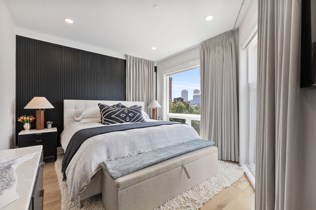 43 Stillman Street, Unit PH Boston, MA 02113 - Photo 11 of 17 a spacious bedroom with a large bed and a window