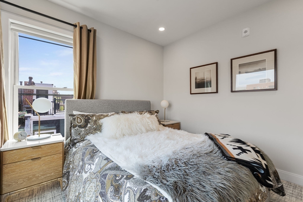 43 Stillman Street, Unit PH Boston, MA 02113 - Photo 13 of 17 a bedroom with a bed and a window