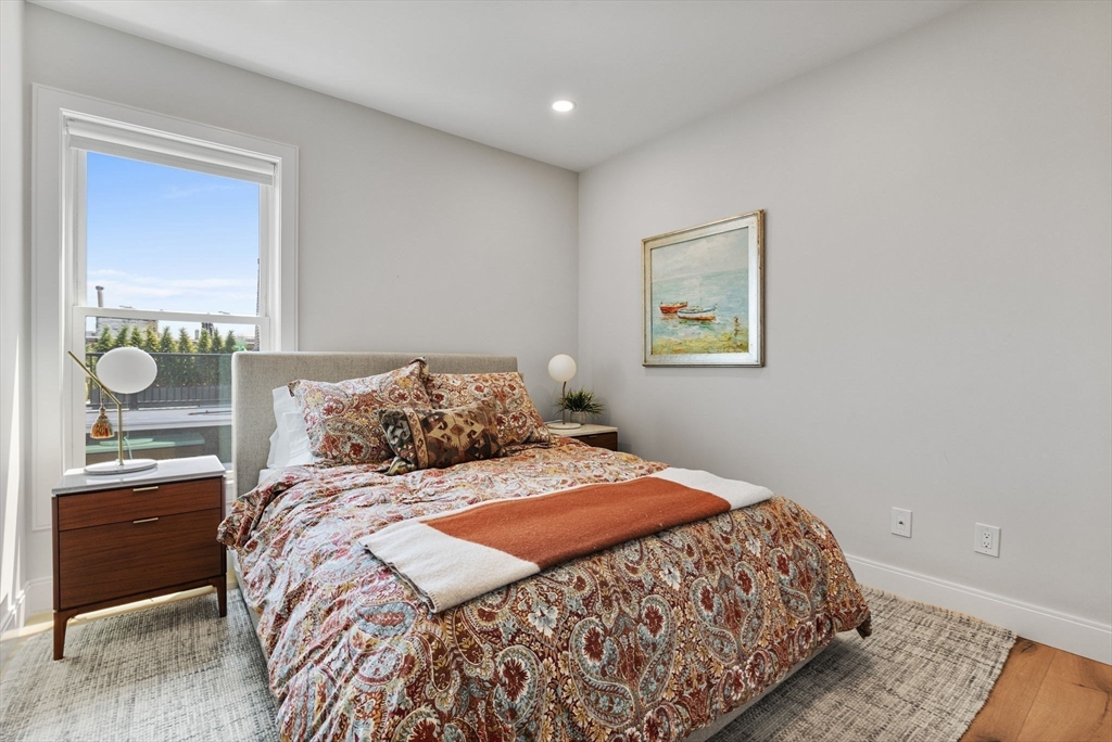 43 Stillman Street, Unit PH Boston, MA 02113 - Photo 14 of 17 a bedroom with a bed and lamps