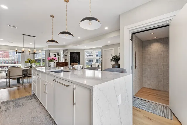 a kitchen with stainless steel appliances granite countertop a sink and a refrigerator