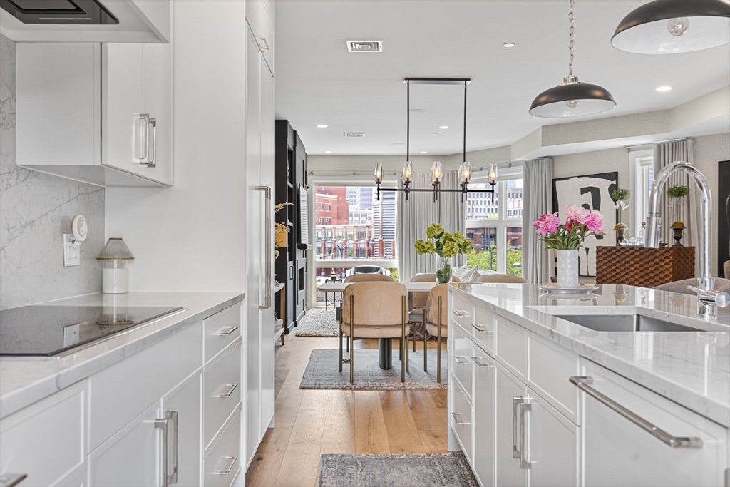 43 Stillman Street, Unit PH Boston, MA 02113 - Photo 5 of 17 a kitchen with stainless steel appliances kitchen island granite countertop a sink and cabinets