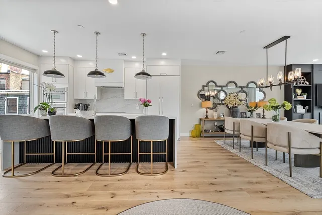 a large kitchen with a table and chairs