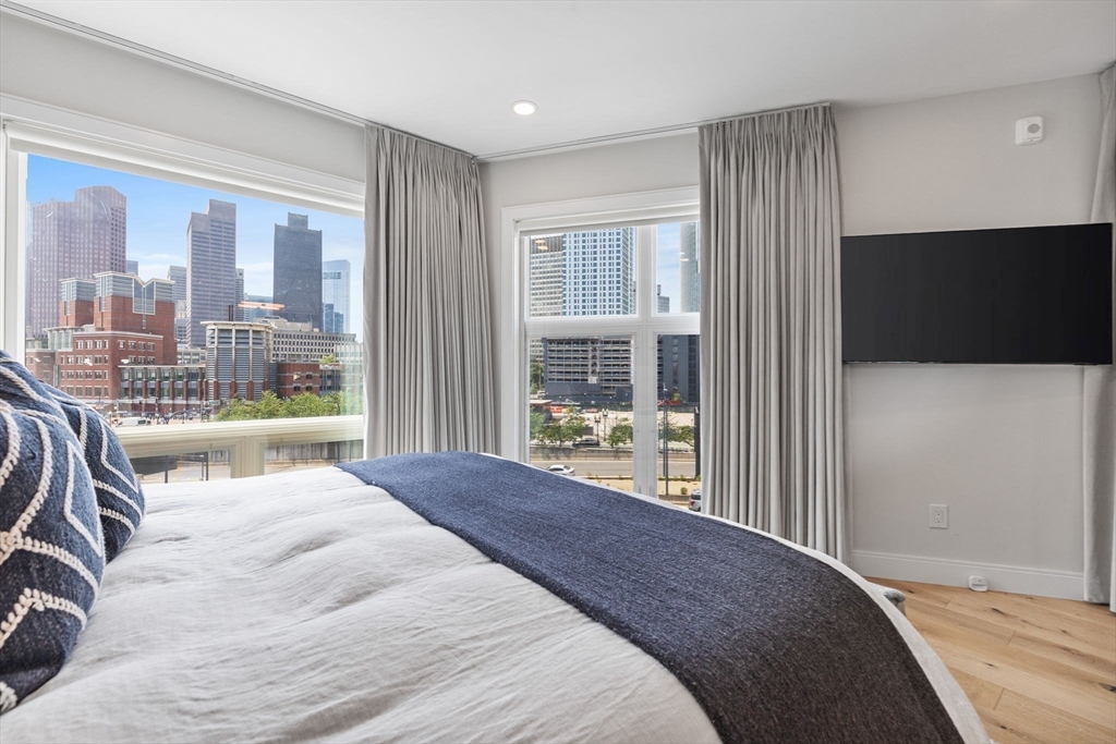 43 Stillman Street, Unit PH Boston, MA 02113 - Photo 9 of 17 a bedroom with a large bed and a flat tv screen