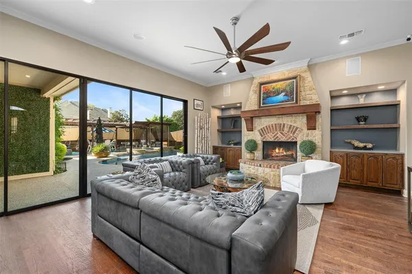 a living room with furniture a large window and a fireplace
