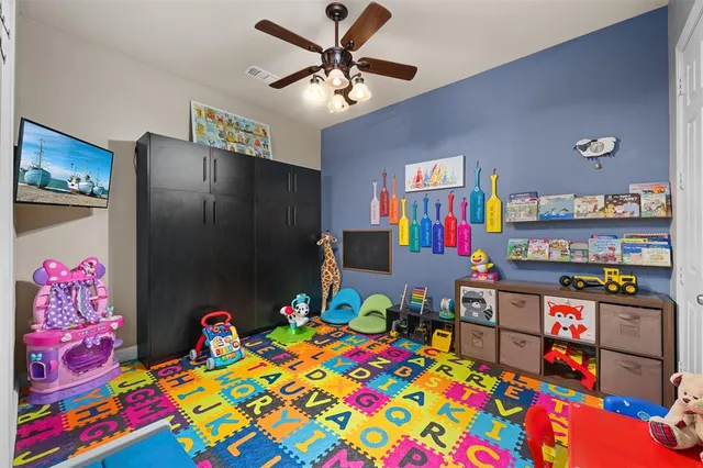 a bedroom with a bed and a desk