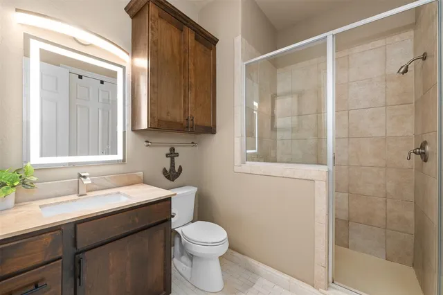 a bathroom with a sink toilet and shower