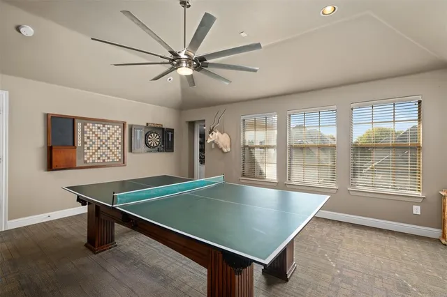 a room with pool table and windows