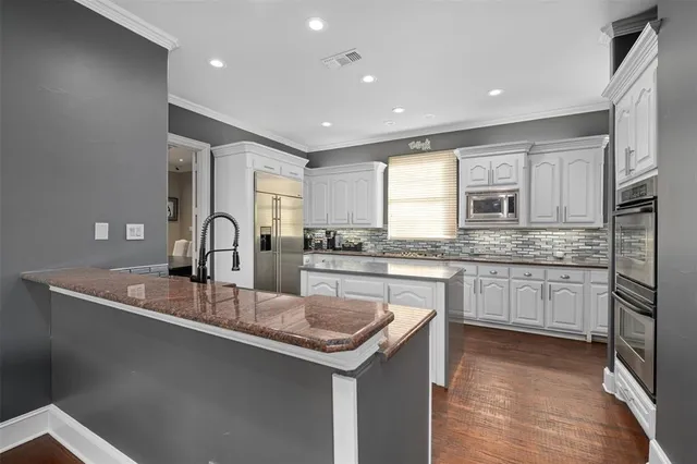 a kitchen with a sink window and refrigerator