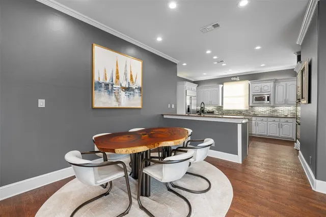 a kitchen with a sink cabinets and dining table