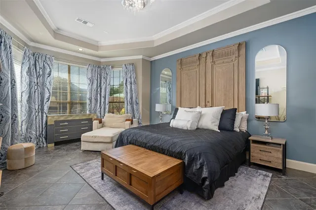 a living room with a bed furniture and a large window