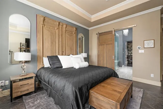 a bedroom with a bed and a lamp