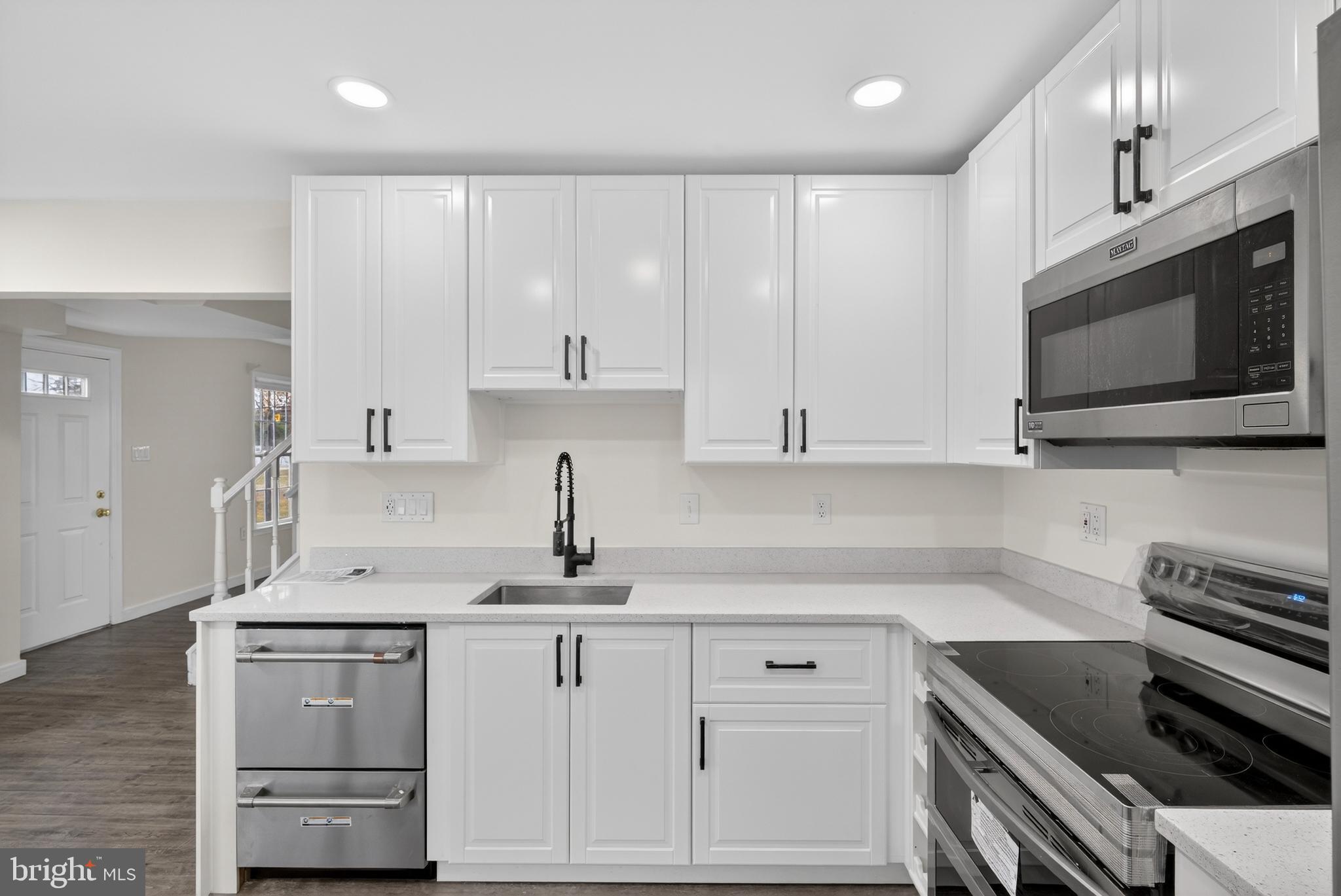 6476 Franconia Court Springfield, VA 22150 - Photo 11 of 41 a kitchen with granite countertop a sink stainless steel appliances and cabinets