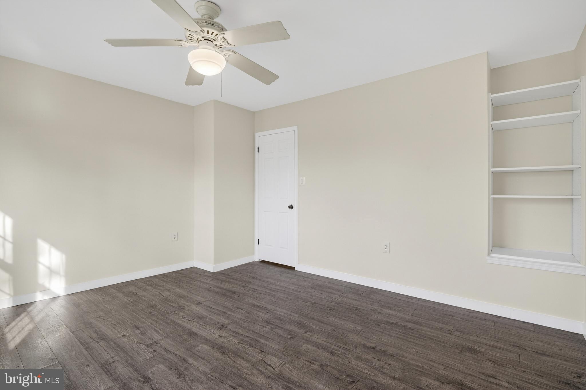 6476 Franconia Court Springfield, VA 22150 - Photo 18 of 41 a view of a room with wooden floor and a ceiling fan