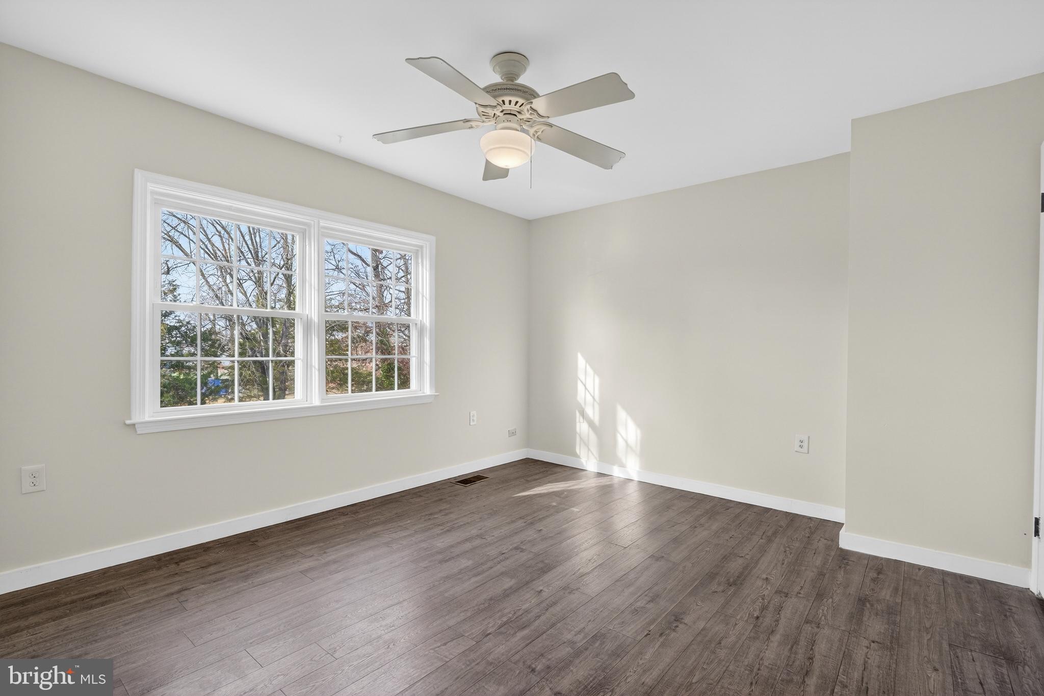 6476 Franconia Court Springfield, VA 22150 - Photo 19 of 41 a view of an empty room with wooden floor and a window