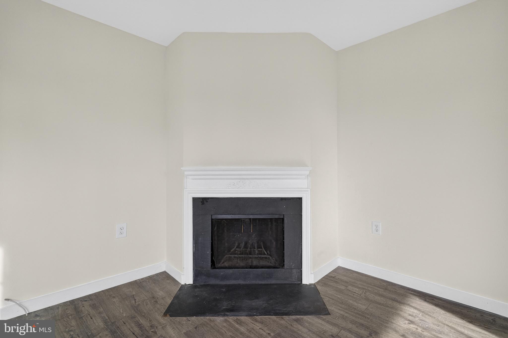 6476 Franconia Court Springfield, VA 22150 - Photo 5 of 41 a view of an empty room with wooden floor and a fireplace