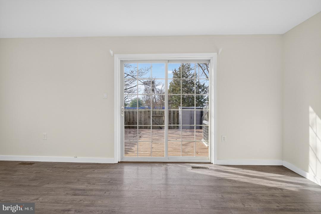 6476 Franconia Court Springfield, VA 22150 - Photo 6 of 41 an empty room with wooden floor and windows