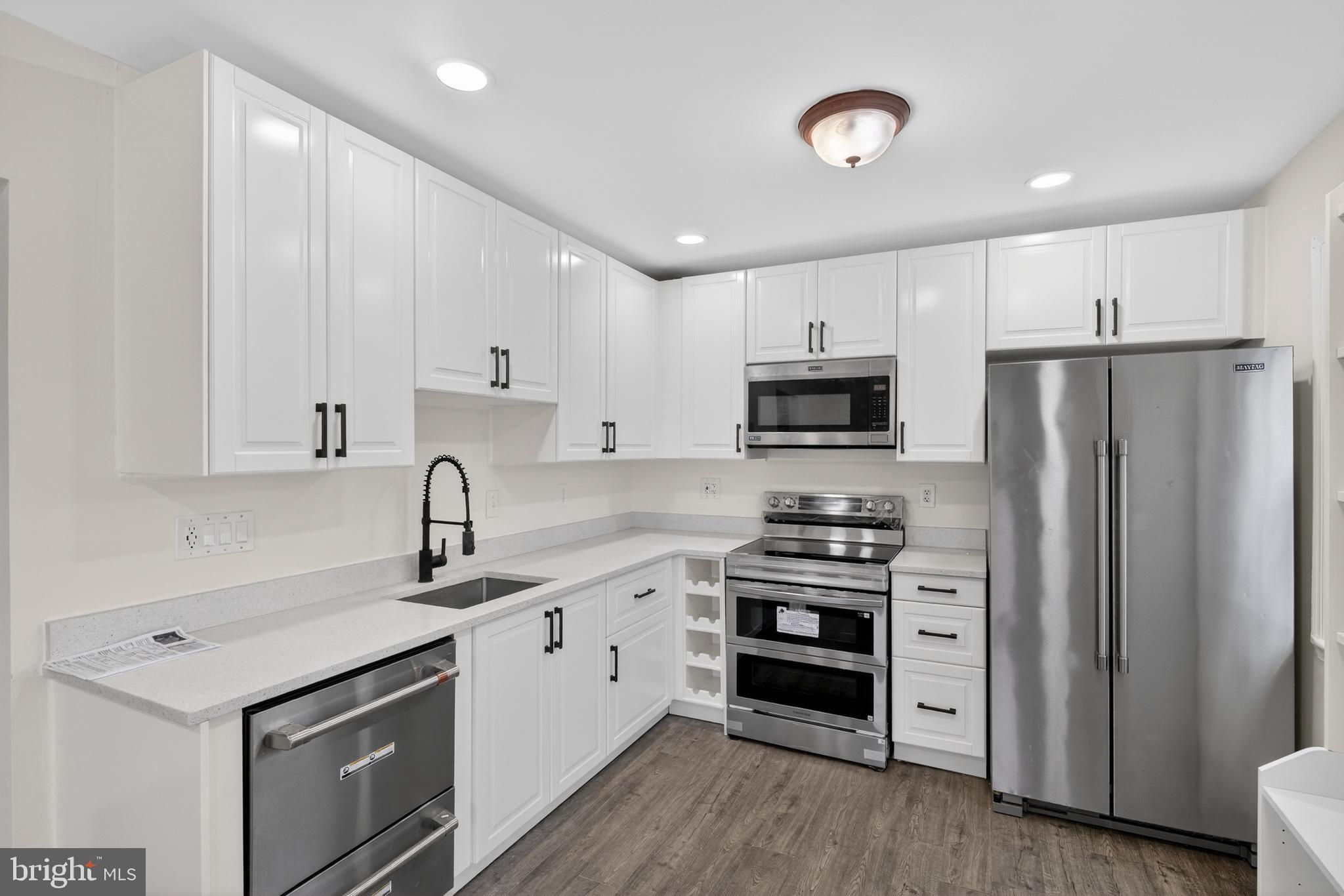 6476 Franconia Court Springfield, VA 22150 - Photo 10 of 41 a kitchen with granite countertop a sink stainless steel appliances and cabinets