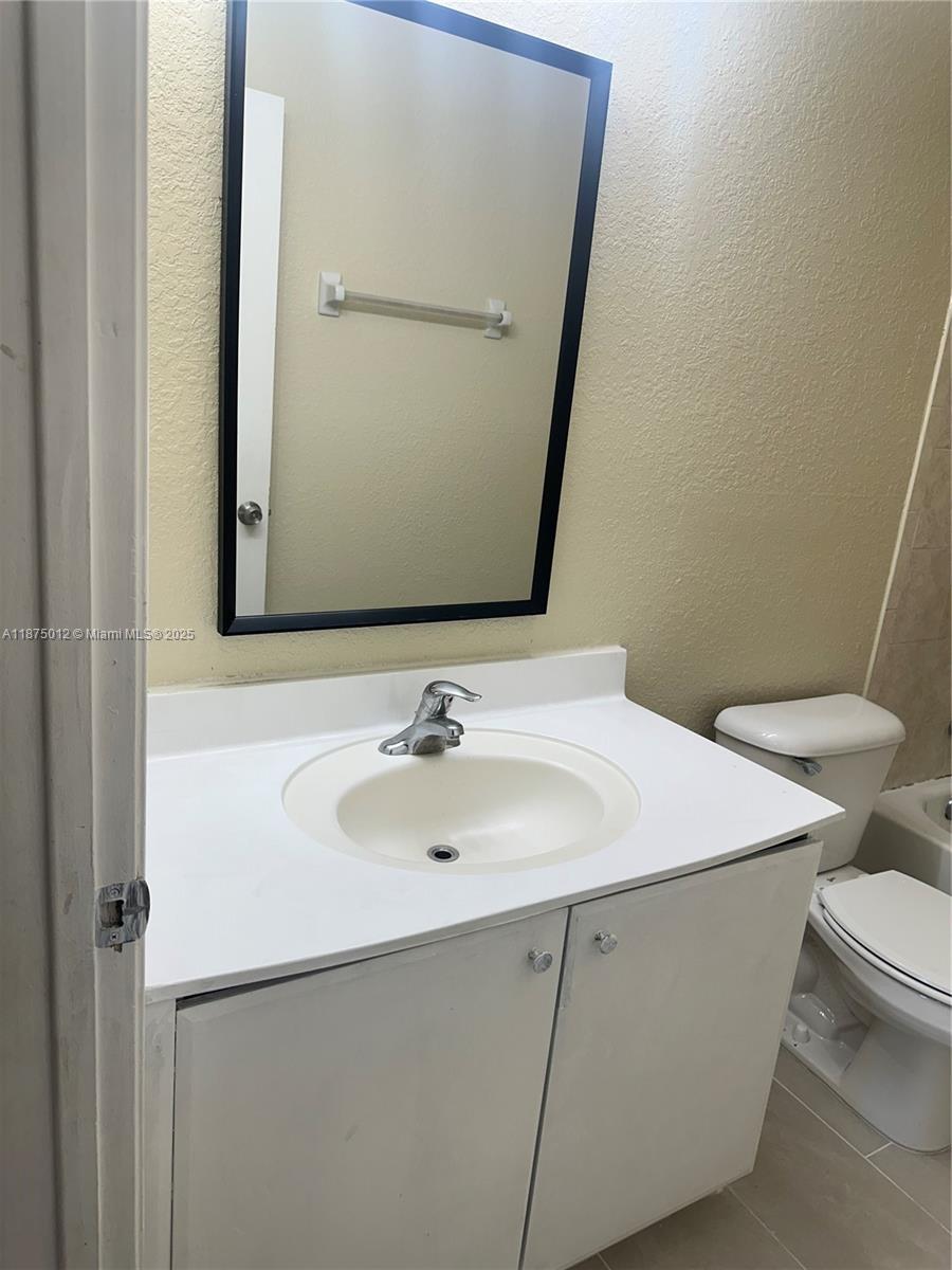 2834 Southeast 16th Avenue, Unit 111 Homestead, FL 33035 - Photo 17 of 22 a bathroom with a sink and a toilet