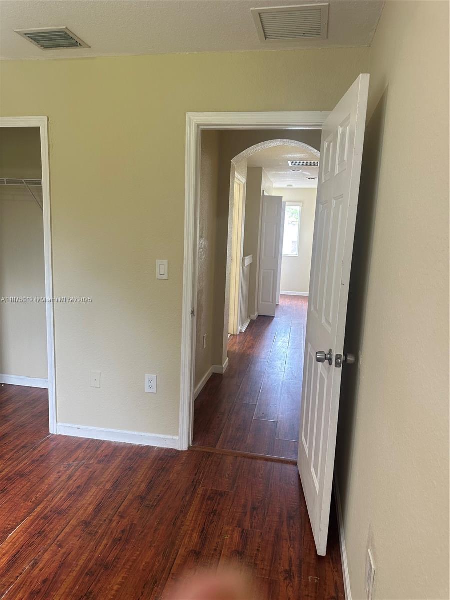 2834 Southeast 16th Avenue, Unit 111 Homestead, FL 33035 - Photo 21 of 22 wooden floor in a hallway with wooden floor