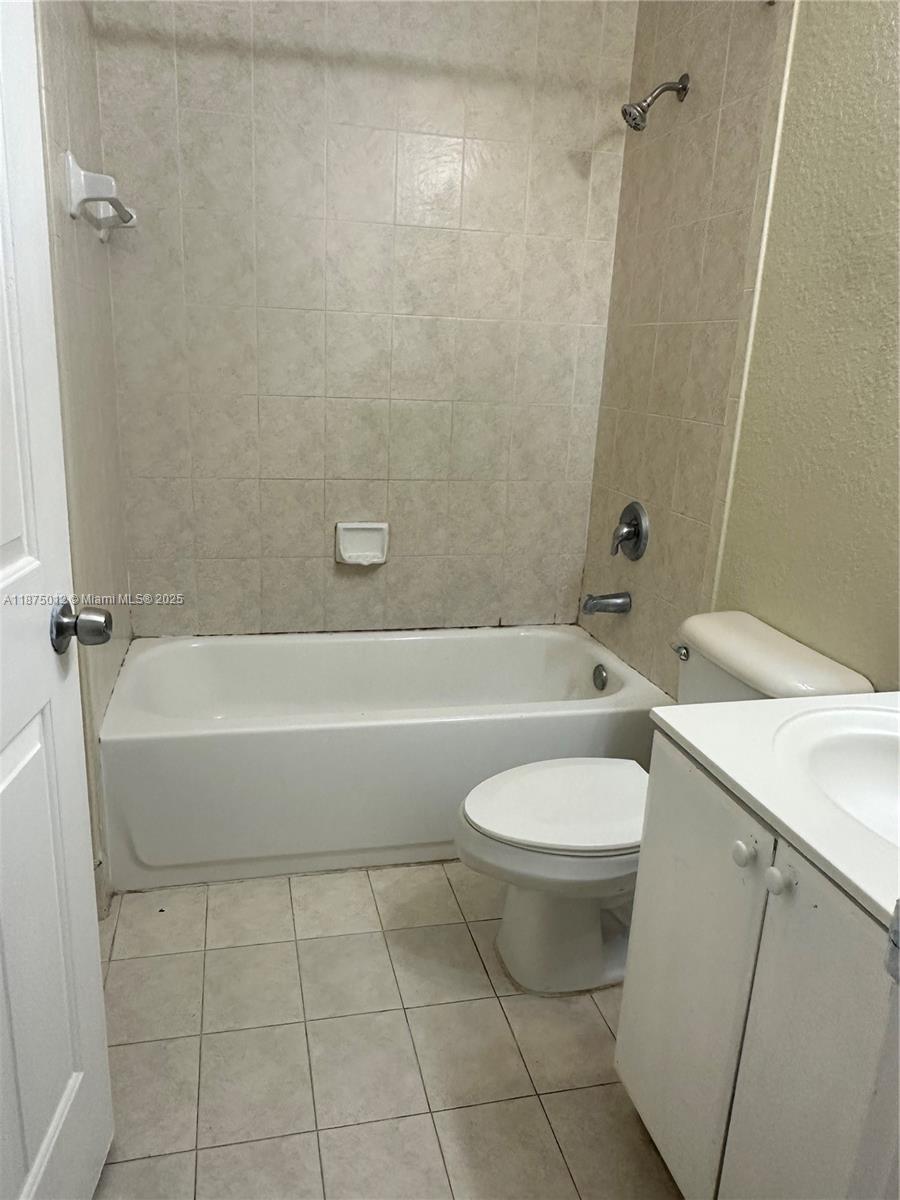 2834 Southeast 16th Avenue, Unit 111 Homestead, FL 33035 - Photo 6 of 22 a bathroom with a sink a toilet and bathtub