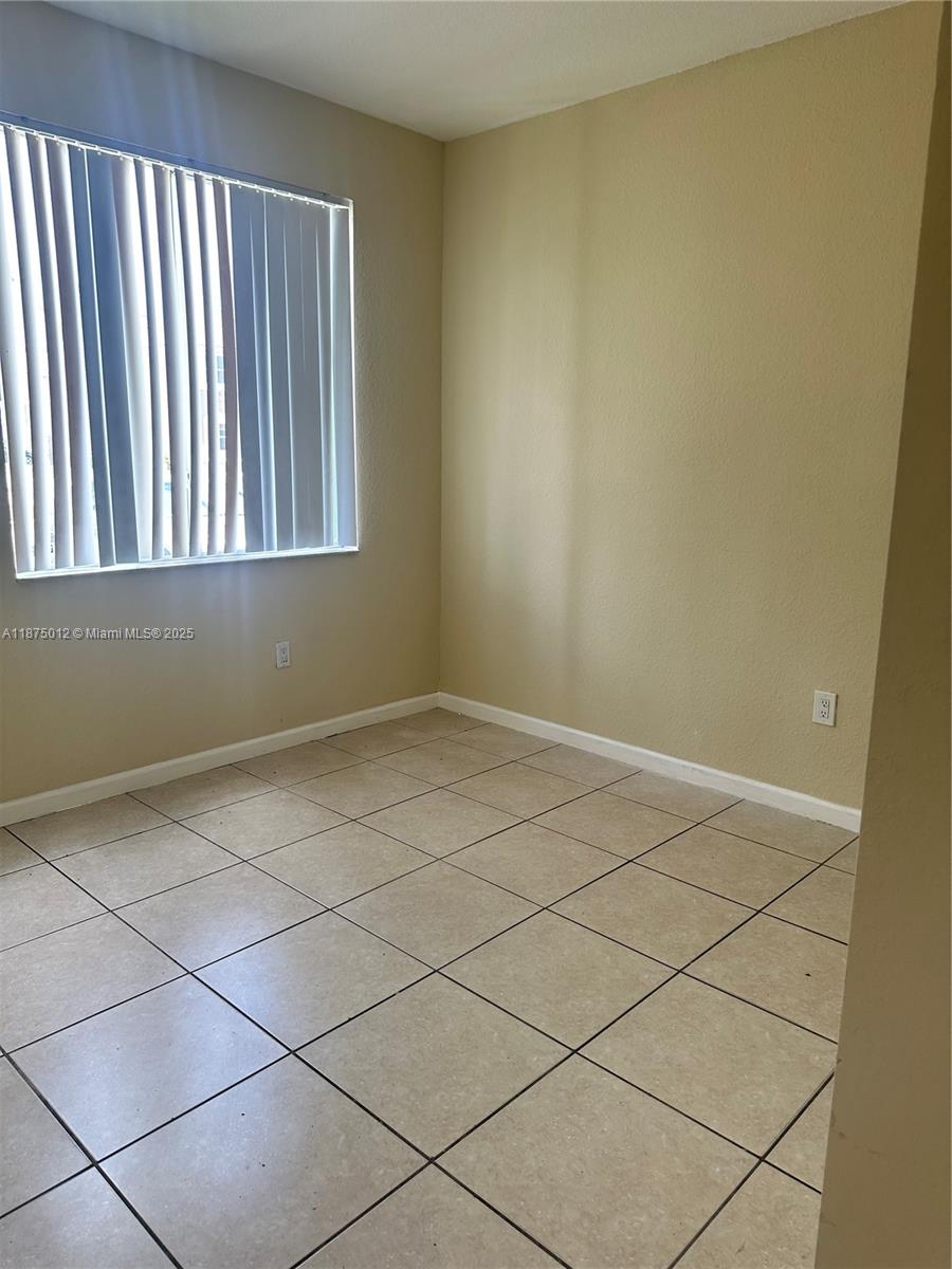 2834 Southeast 16th Avenue, Unit 111 Homestead, FL 33035 - Photo 8 of 22 a view of a room that has a window in it