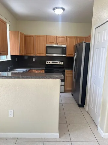 a kitchen with stainless steel appliances a refrigerator and a sink