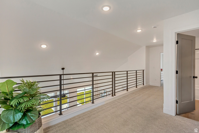 1389 1440 East, Unit 1 Payson, UT 84651 - Photo 14 of 17 Upper-level landing featuring a contemporary horizontal bar railing, recessed ceiling lighting, and light-toned carpet flooring