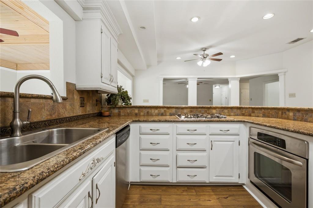 265 East Dove Road Southlake, TX 76092 - Photo 14 of 39 a kitchen with granite countertop a sink cabinets and stainless steel appliances