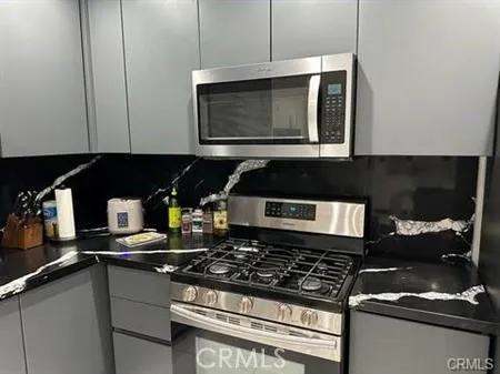 a kitchen with a stove and a microwave