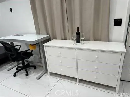 a view of a room with a table and chairs