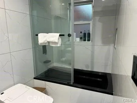 a bathroom with a bathtub and a shower