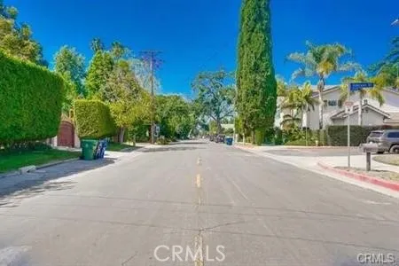 a view of a street with houses on both side