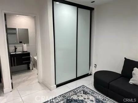 a living room with a couch and a mirror