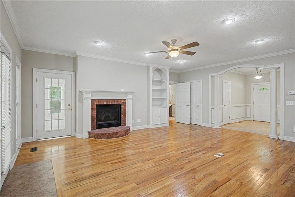 1136 Cole Lake Road Dallas, GA 30157 - Photo 16 of 72 a view of an empty room with a fireplace and a window