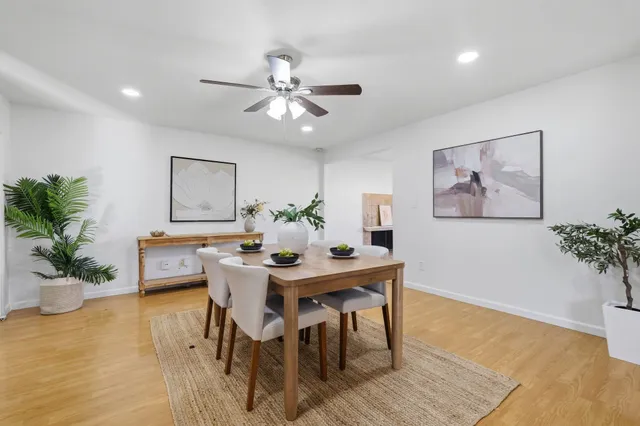 a view of a dining room with furniture and wooden floor