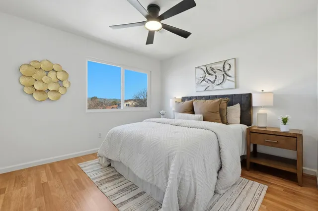 a bedroom with a bed and a painting on the wall