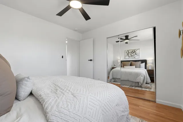 a bedroom with a bed and wooden floor