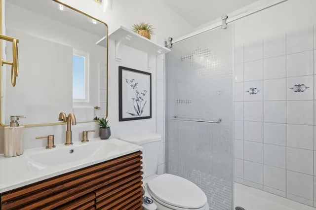 a bathroom with a sink toilet and shower