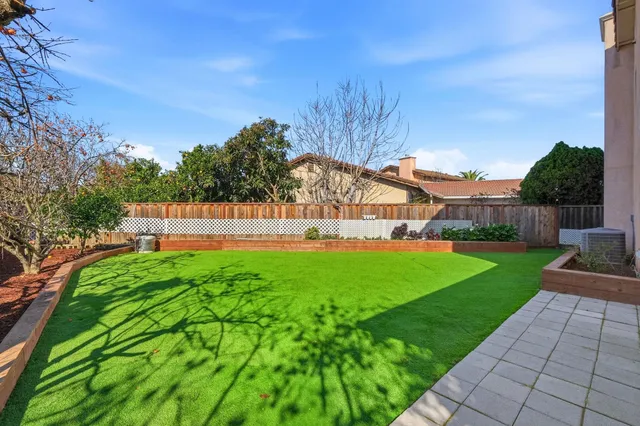 a view of a garden with a building in the background