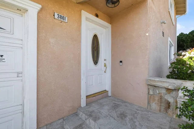 a view of a livingroom with wooden floor and a large window