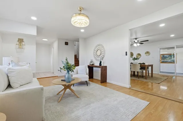 a living room with furniture and wooden floor